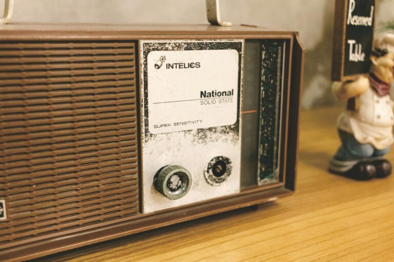 Close-up of a National Solid State vintage radio on a wooden table, featuring retro design and classic technology.