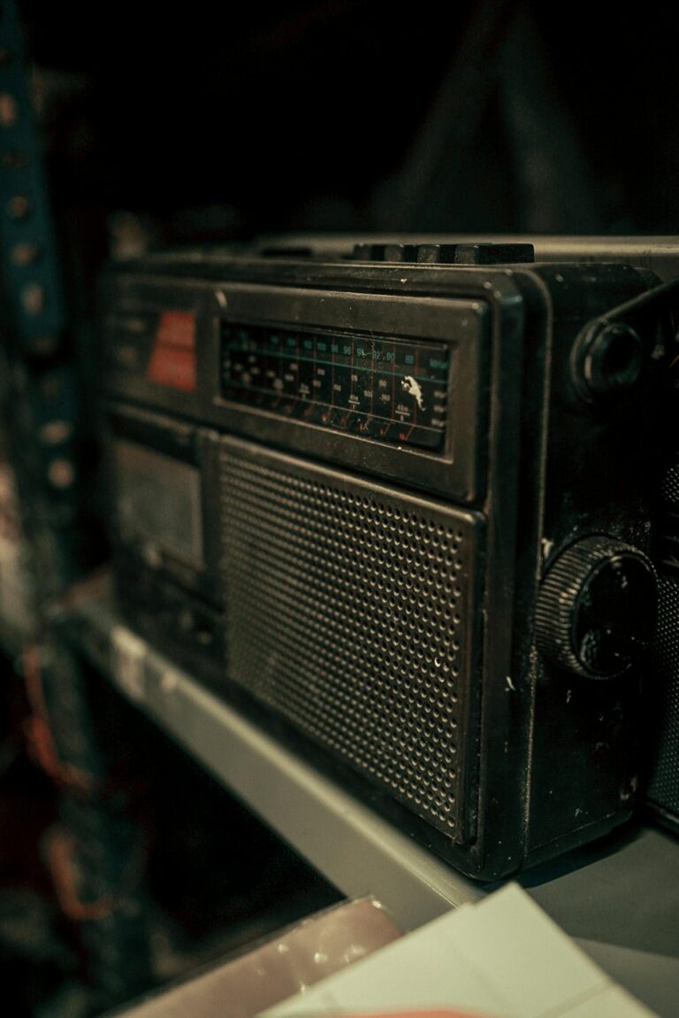 Close-up of a vintage radio with a retro design on a shelf, capturing nostalgic charm.
