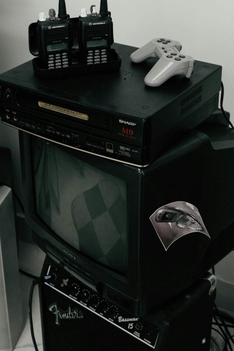 Vintage setup featuring old TV, walkie talkies, and gaming console, ideal for nostalgic themes.