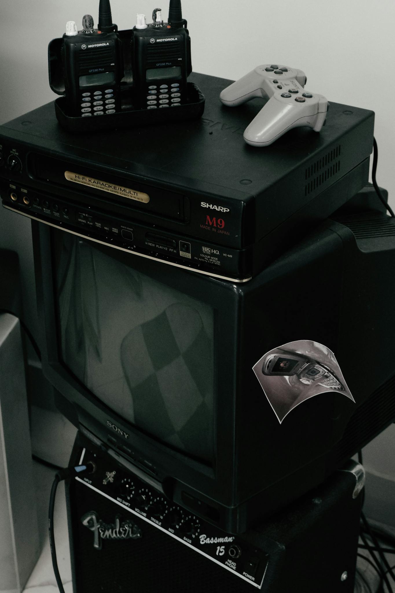 Vintage setup featuring old TV, walkie talkies, and gaming console, ideal for nostalgic themes.